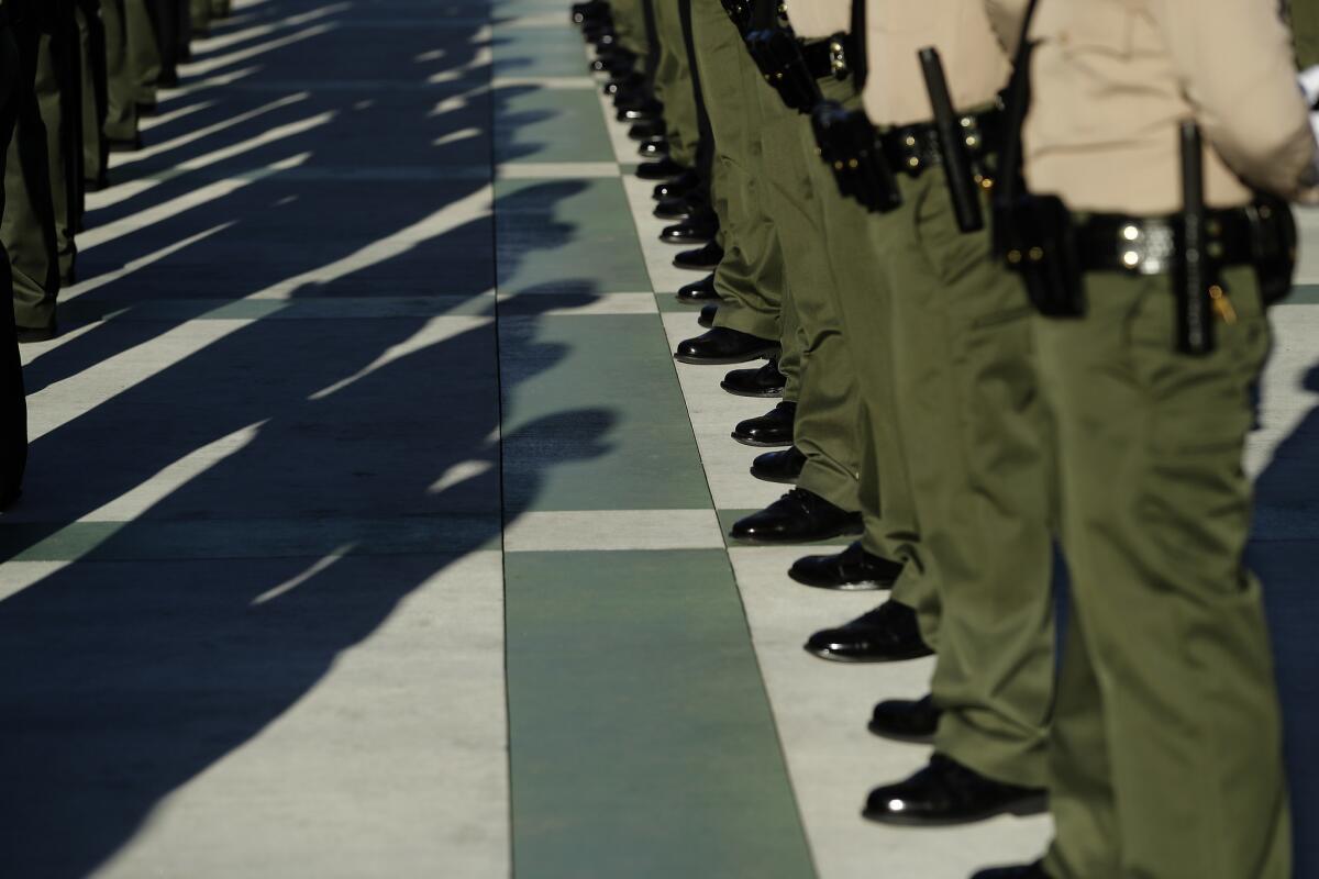 Los Angeles County Sheriff's deputies stand at attention during the inspection portion of their graduation ceremony