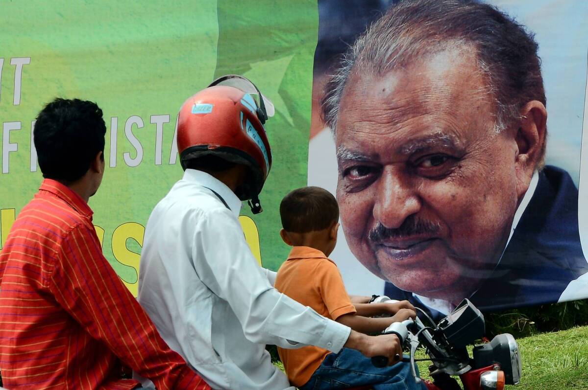 Motorists pass a banner congratulating new President Mamnoon Hussain in Islamabad, Pakistan's capital.