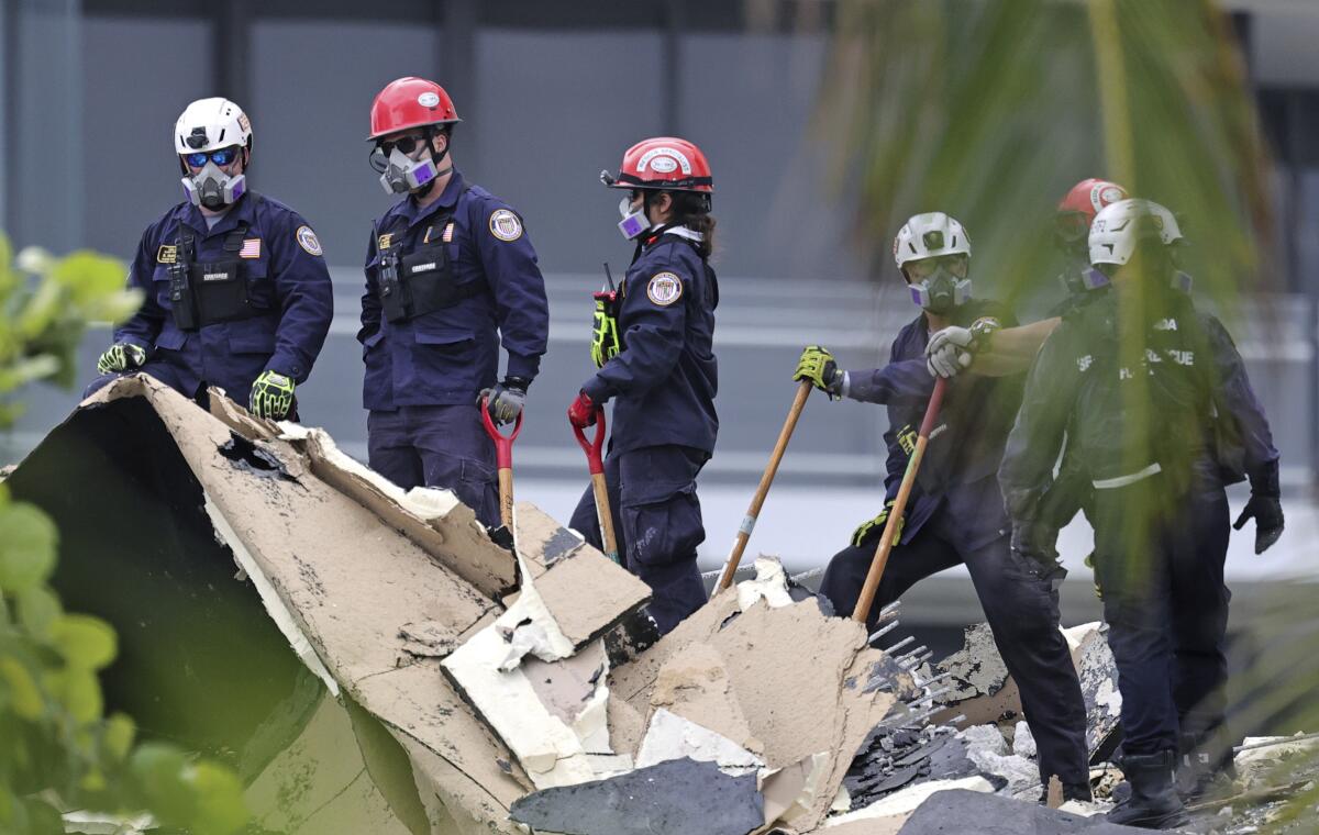 Search and rescue personnel search for survivors at the Champlain Towers South Condo