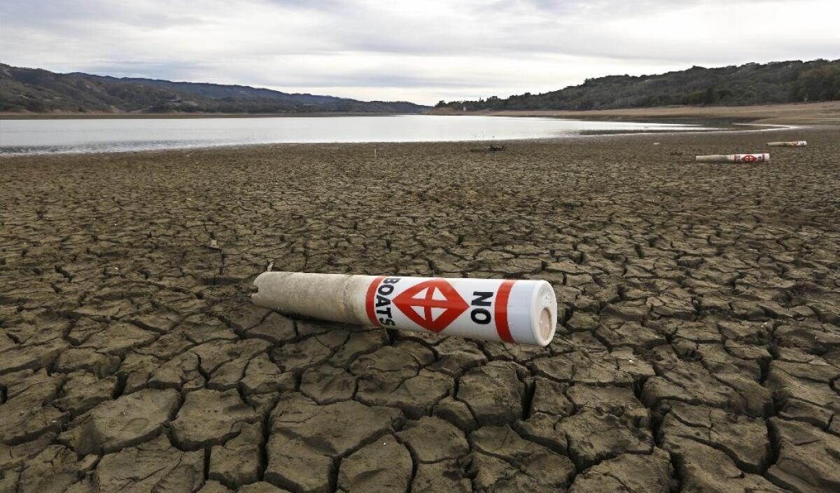A warning buoy sits on the dry, cracked bed of Lake Mendocino near Ukiah.