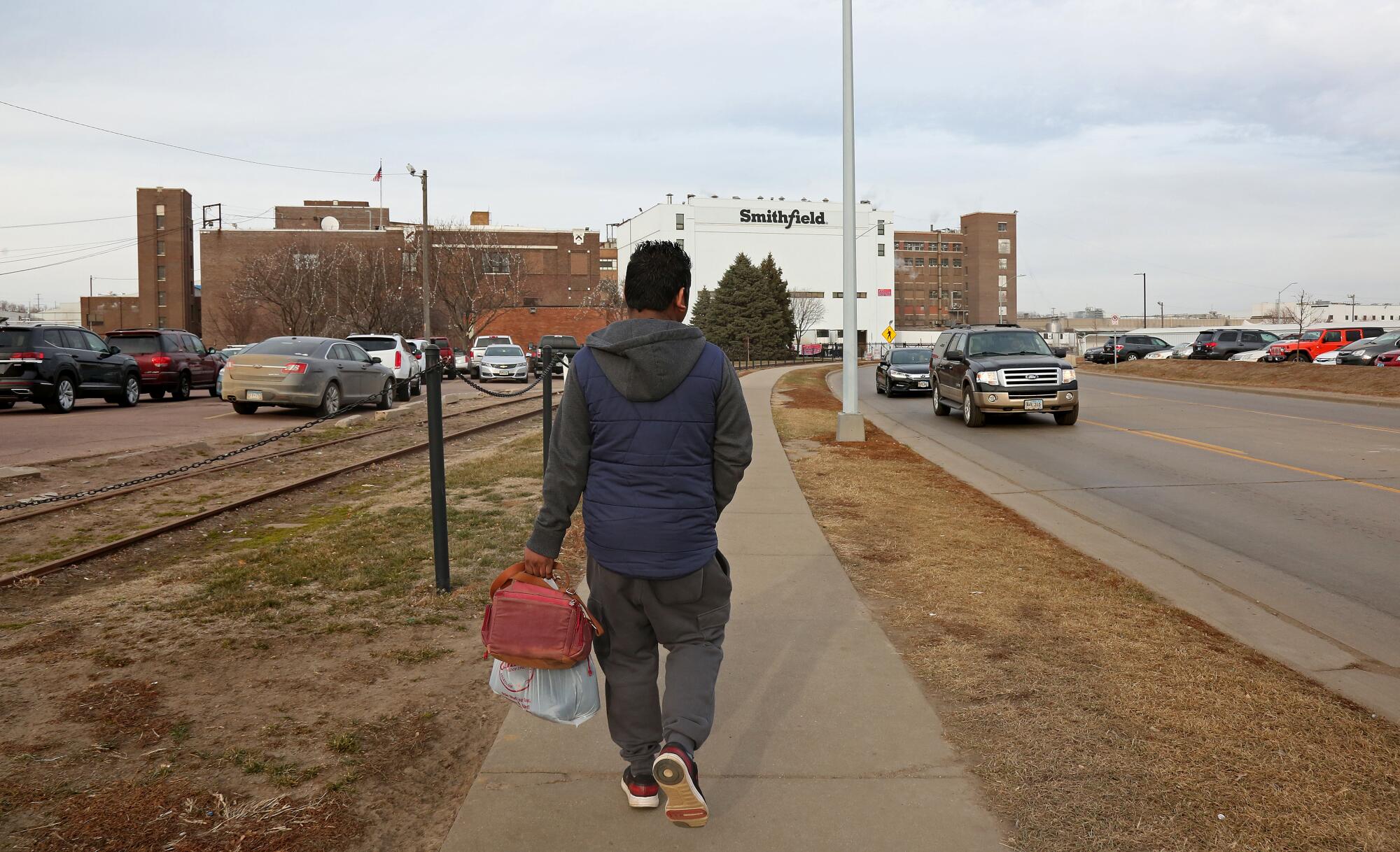 Urwan heads to begin his evening shift at the factory.