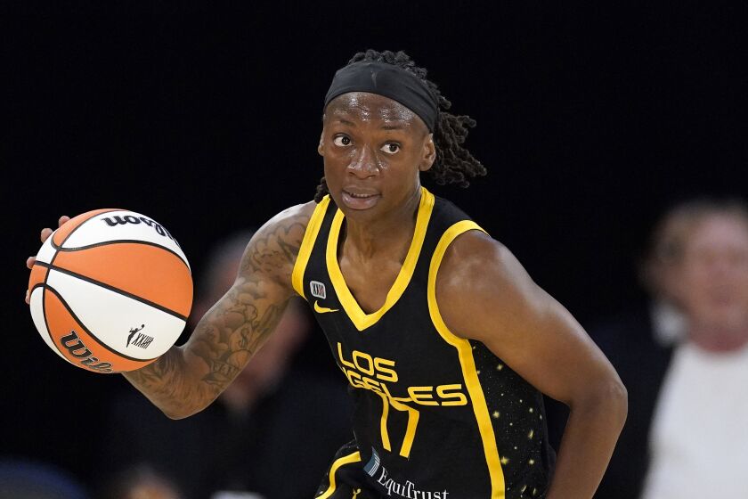 Los Angeles Sparks guard Erica Wheeler dribbles during the first half of a WNBA basketball game against the Las Vegas Aces Friday, July 2, 2021, in Los Angeles. (AP Photo/Mark J. Terrill)