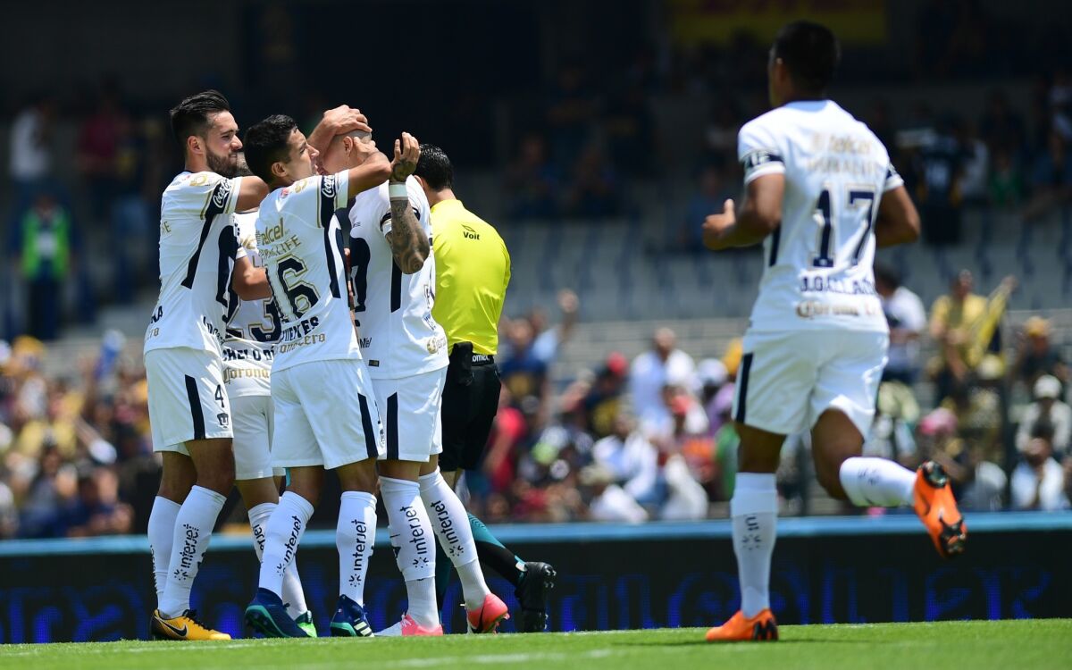 Pumas' Chilean forward Nicolas Castillo (2-R), celabrates with teammates after scoring a goal, during their Mexican Clausura tournament football match against Puebla at the Olympic stadium in Mexico City, on April 15, 2018.