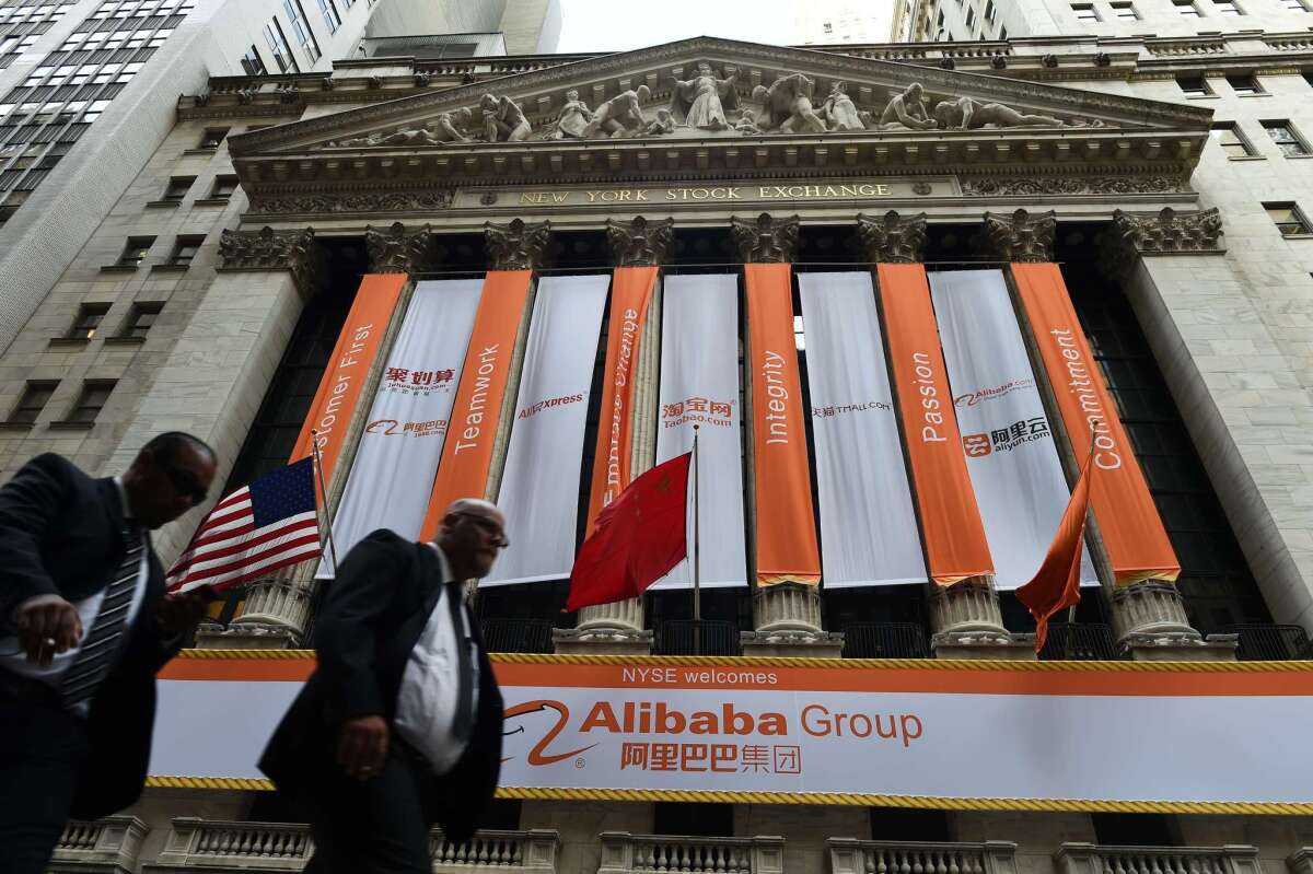 A buying frenzy sent Alibaba shares sharply higher Friday as the Chinese online giant made its historic Wall Street trading debut.