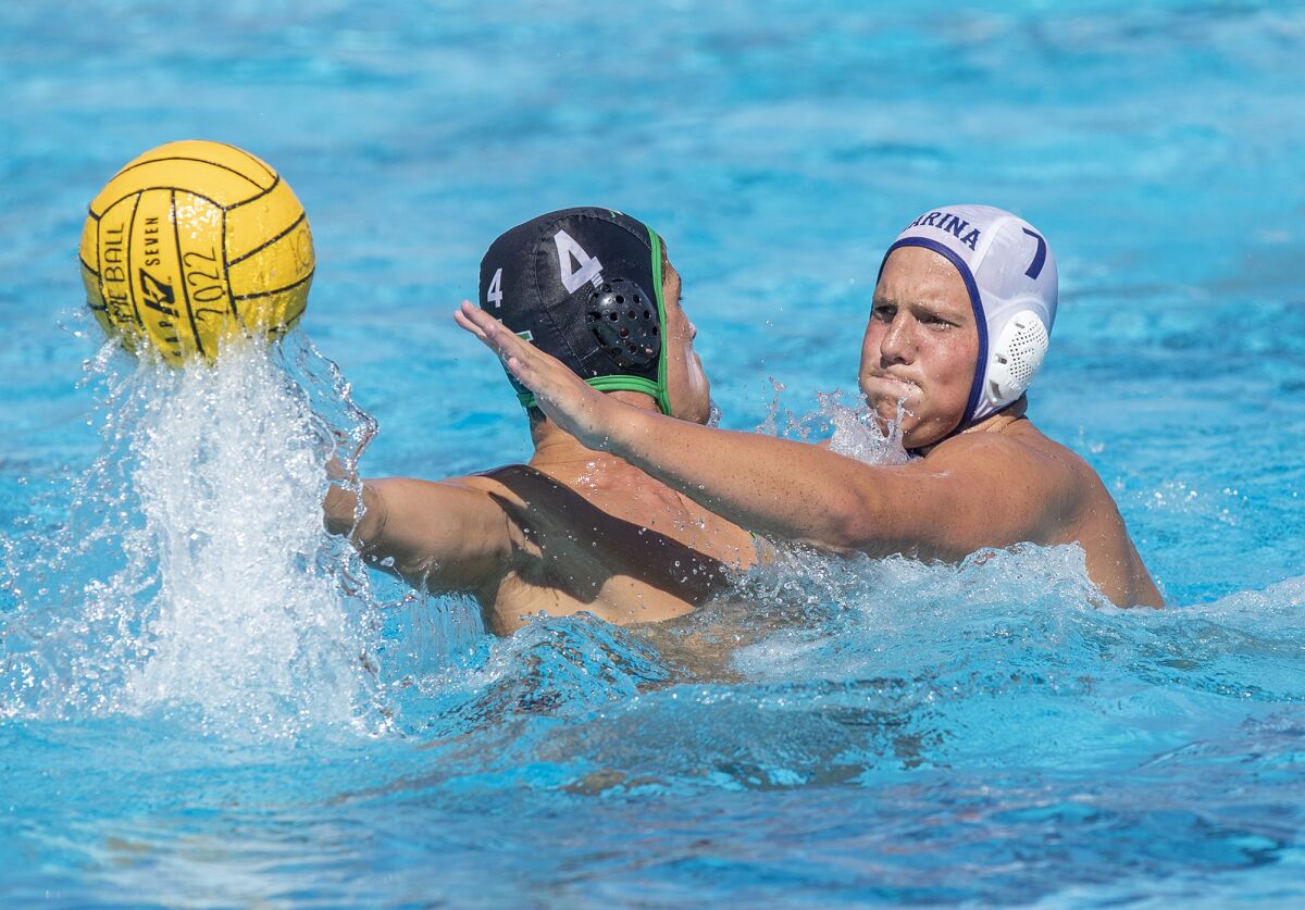 Marina's James Luther puts pressure on Costa Mesa's Wes Brazda during a nonleague game on Aug. 31 in Costa Mesa.