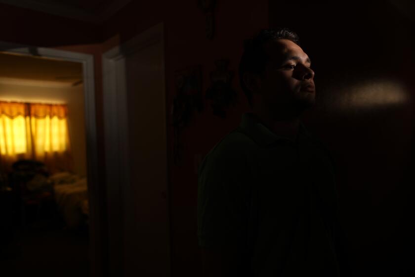 LOS ANGELES, CALIF. -- TUESDAY, JULY 23, 2019: R.S., a 21-year-old immigrant from El Salvador, who received asylum last August 2018, at his aunt's home in Los Angeles, Calif., on July 23, 2019. The Trump administration recently changed asylum rules for unaccompanied minors, and R.S. wouldn't have qualified if he were applying now. (Gary Coronado / Los Angeles Times)