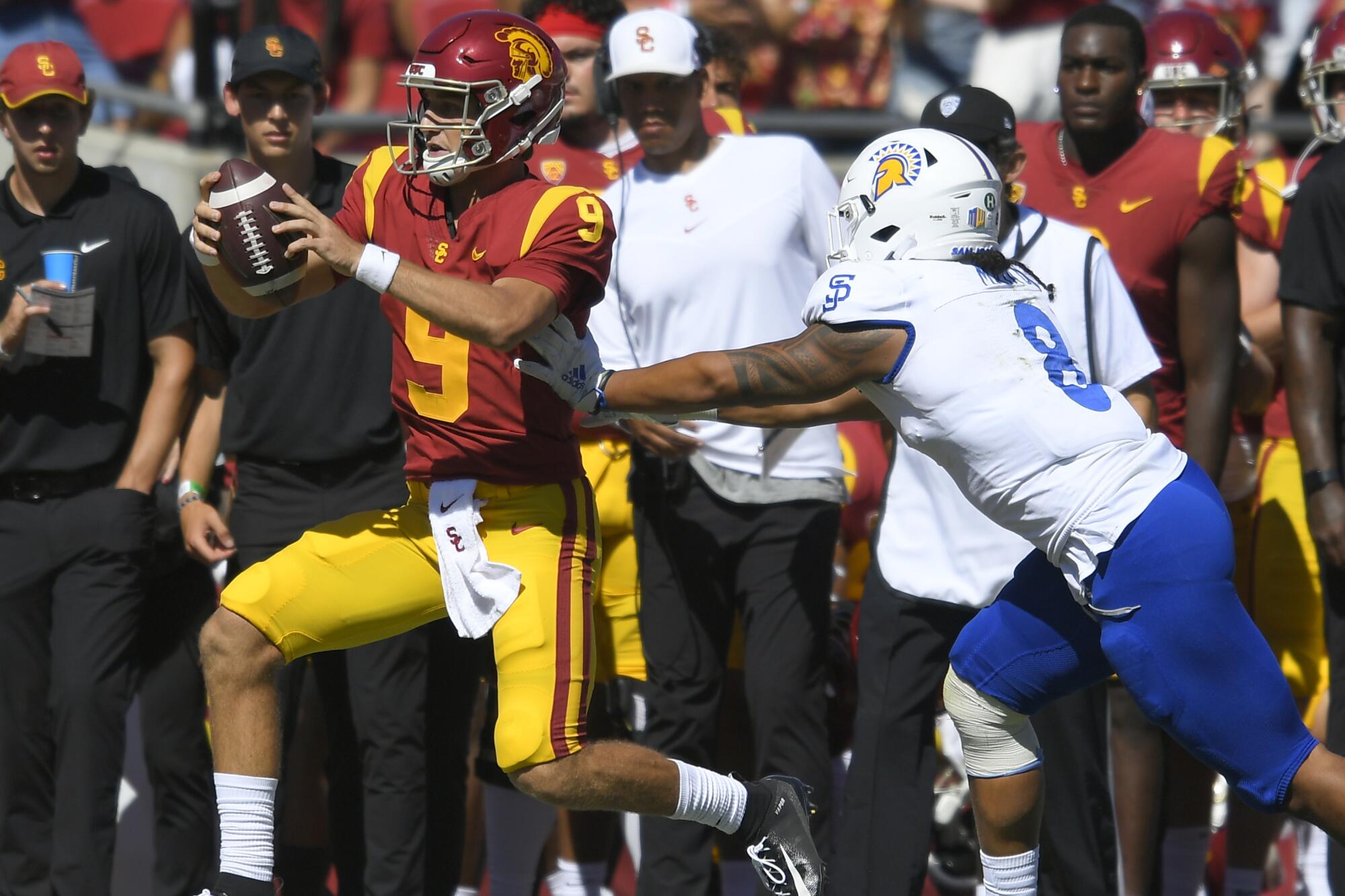 San Jose State linebacker Alii Matau pushes USC quarterback Kedon Slovis out of bounds 