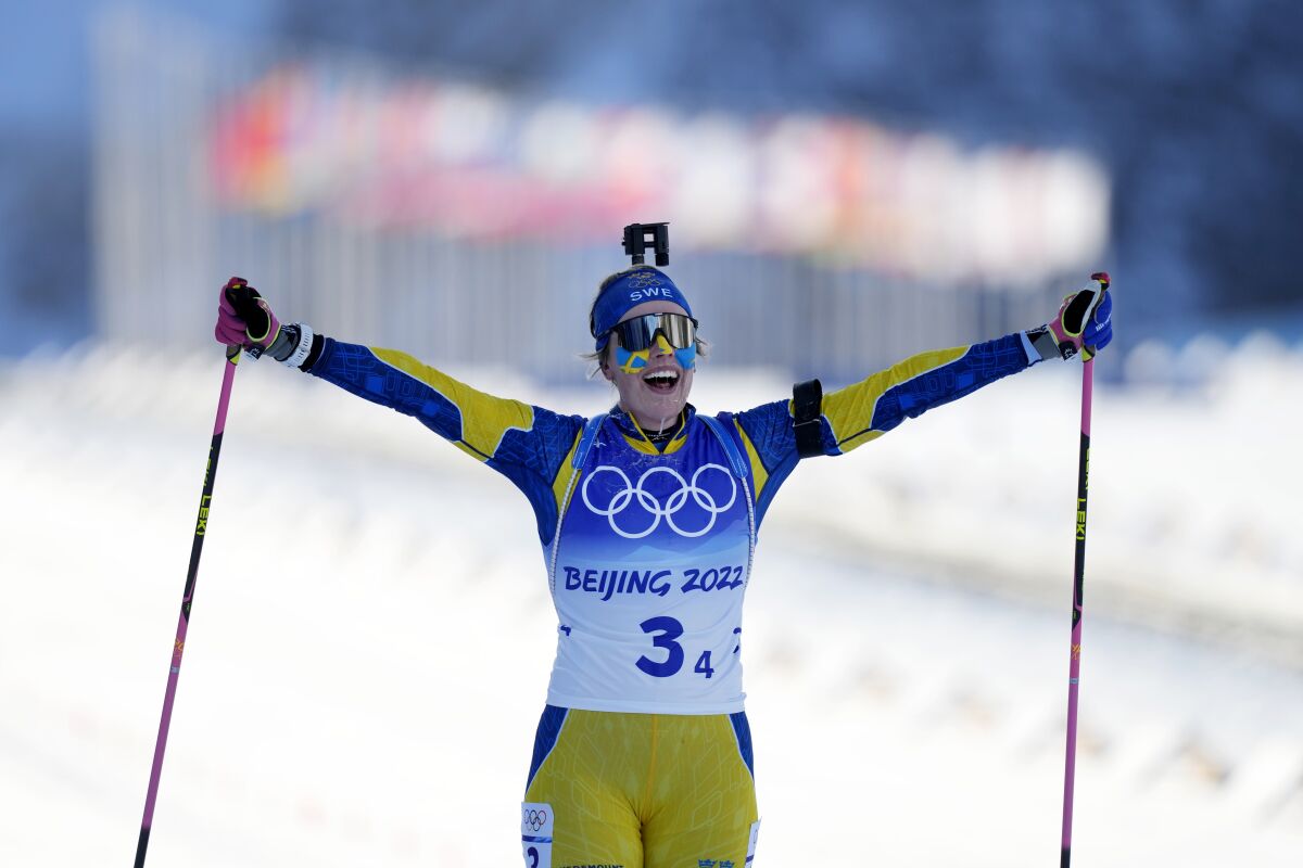 Elvira Oeberg of Sweden crosses the finish line in first during the women's 4x6-kilometer relay at the 2022 Winter Olympics, Wednesday, Feb. 16, 2022, in Zhangjiakou, China. (AP Photo/Frank Augstein)