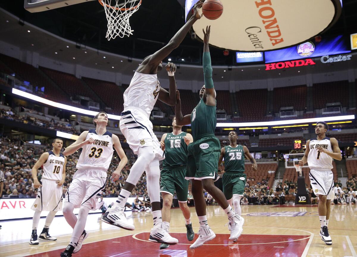 UC Irvine's 7-foot-6 center Mamadou Ndiaye blocks the shot of Hawaii guard Isaac Fleming in the Big West Conference tournament championship.