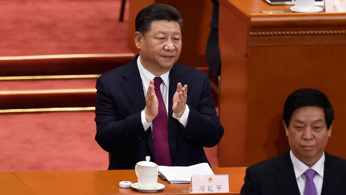 Chinese President Xi Jinping applauds during the opening session of the National People's Congress in Beijing on March 5.