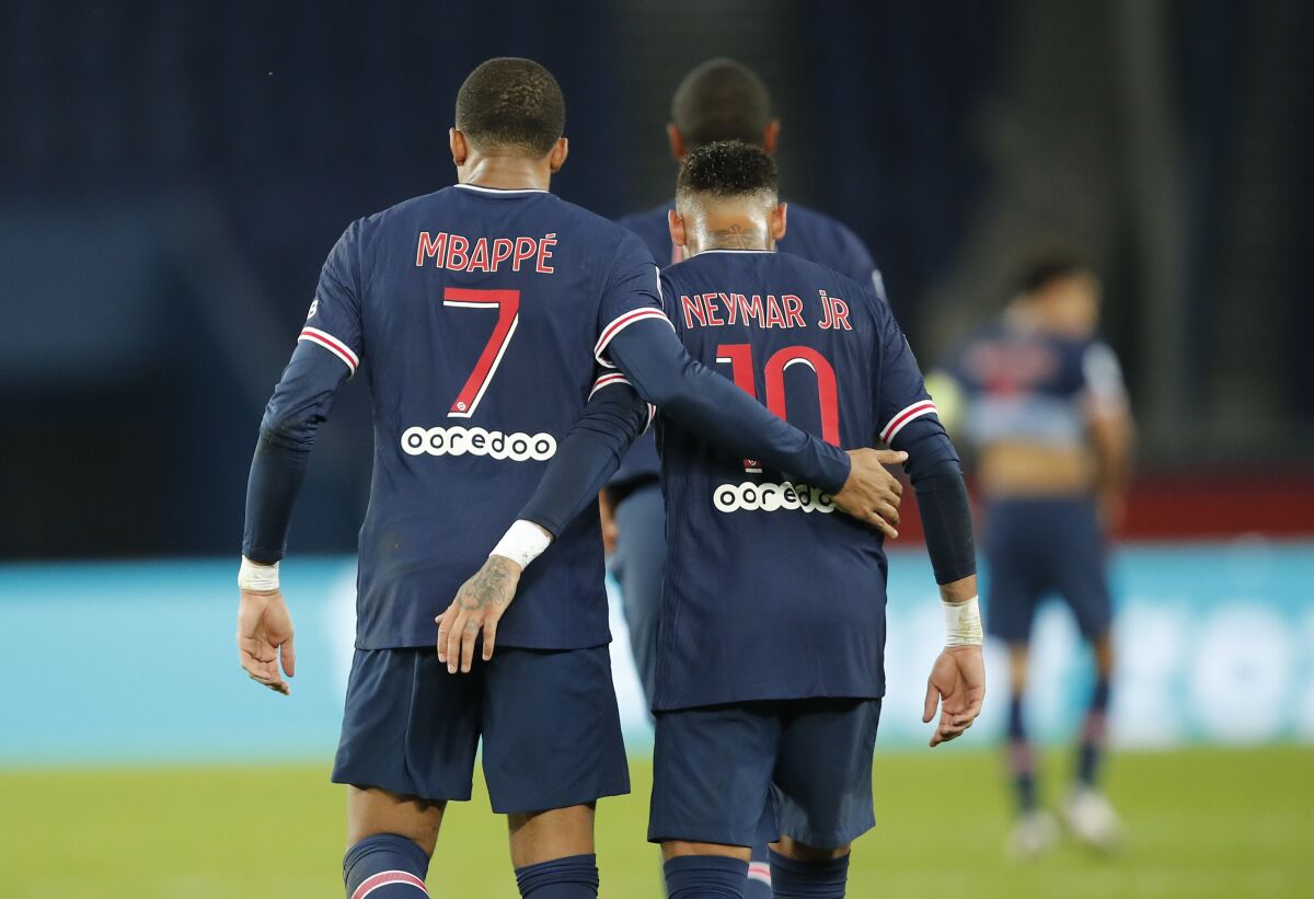 PSG's Kylian Mbappe celebrates with Neymar after scoring his side's sixth goal during the French League One soccer match between Paris Saint-Germain and Angers at the Parc des Princes in Paris, France, Friday, Oct. 2, 2020. (AP Photo/Francois Mori)