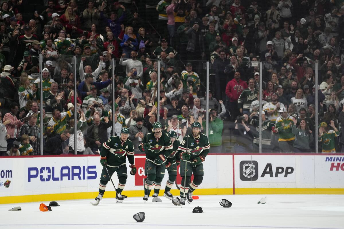 Minnesota Wild goaltender Filip Gustavsson (32) celebrates with left wing Marcus  Foligno (17) after an NHL