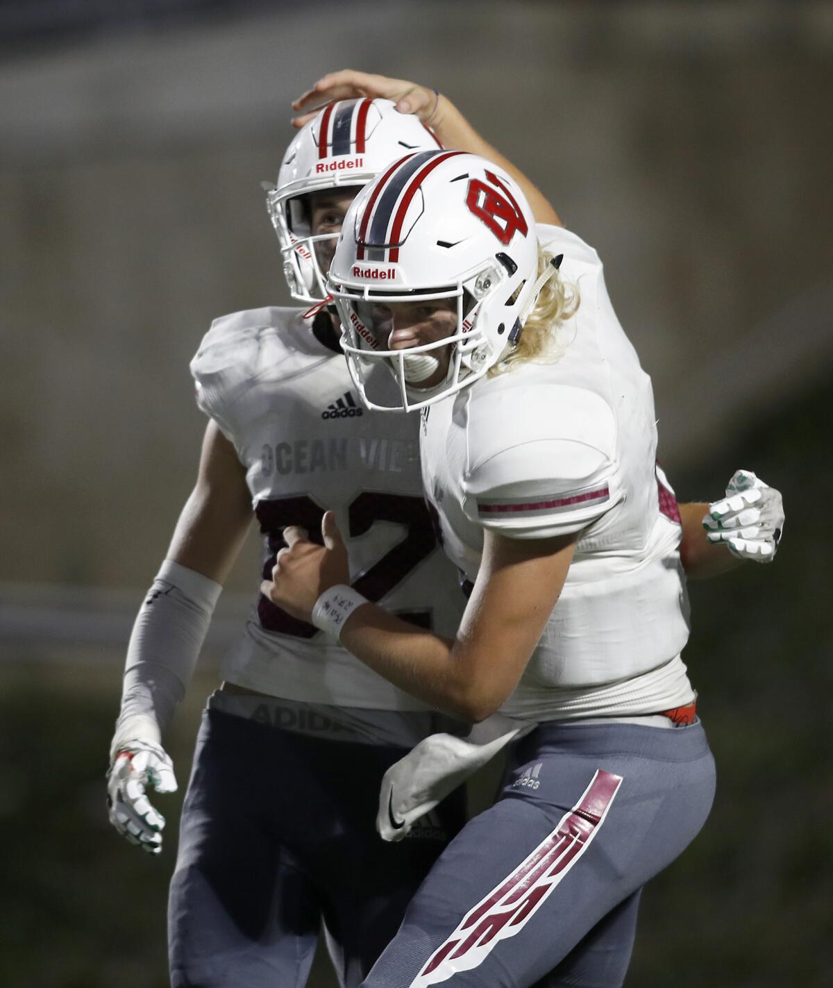 Ocean View quarterback Braden Crabtree, right, celebrates with receiver Brandon Alcaraz after the two hooked up for a 10-yard touchdown pass in the second quarter against Estancia at Orange Coast College on Sept. 19.