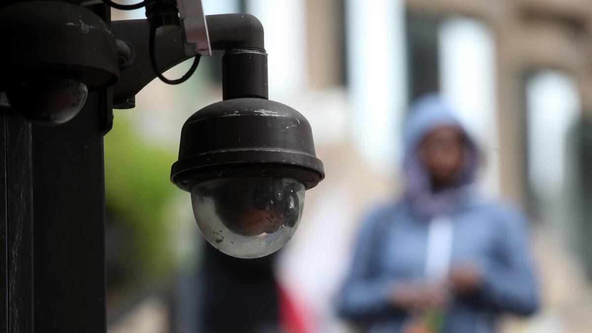 A video surveillance camera hangs from the side of a building in San Francisco on May 14.