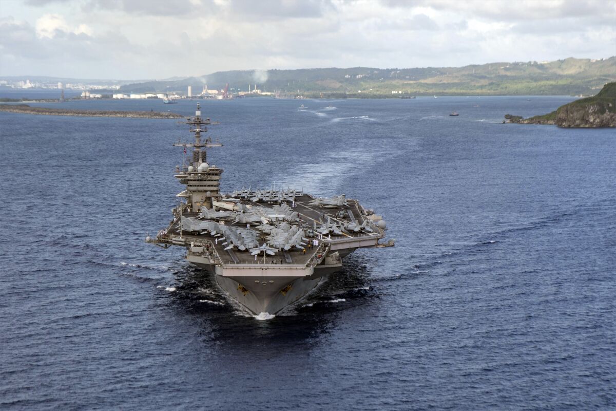 Navy aircraft carrier Theodore Roosevelt departs Apra Harbor in Guam. 