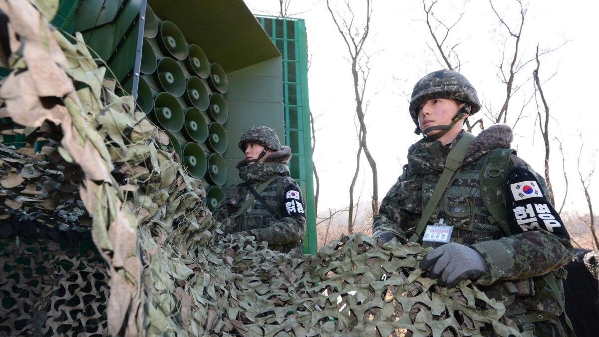 South Korean soldiers remove camouflage from loudspeakers near the border with North Korea in Yeoncheon, South Korea, in 2016.