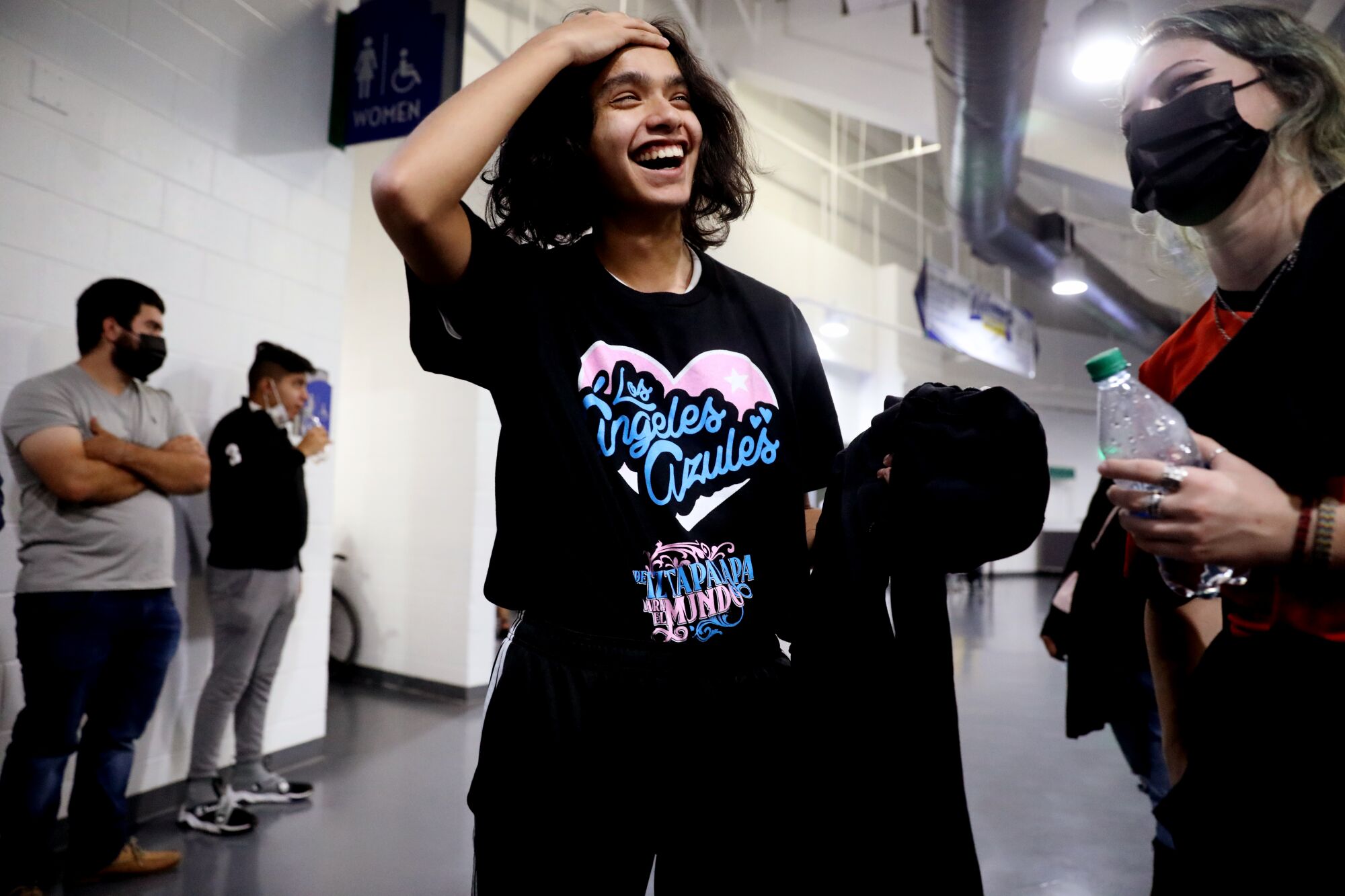A smiling fan wears a band T-shirt 