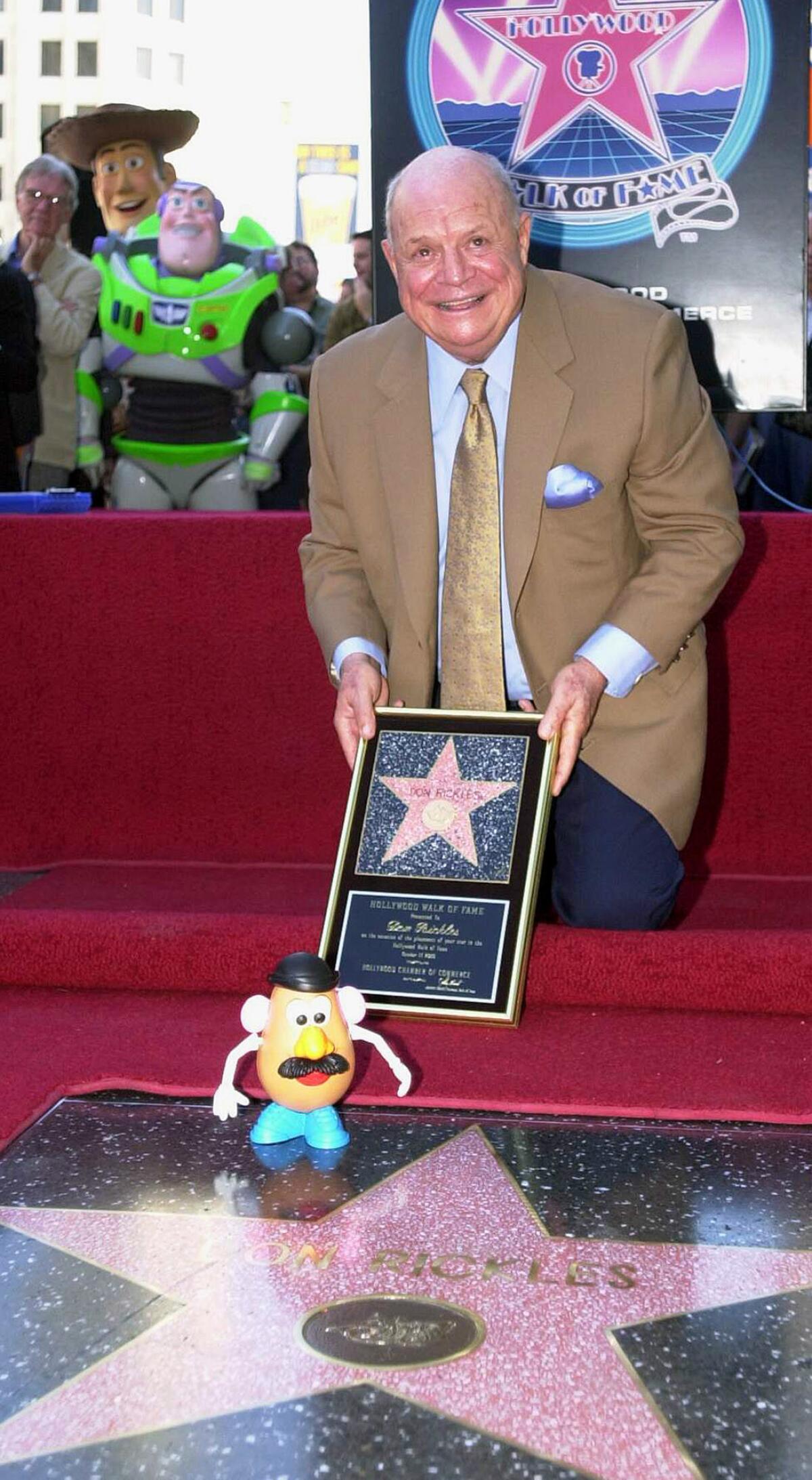 Don Rickles smiles for photographers while receiving his star on the Hollywood Walk of Fame in Los Angeles on Oct. 17, 2000.