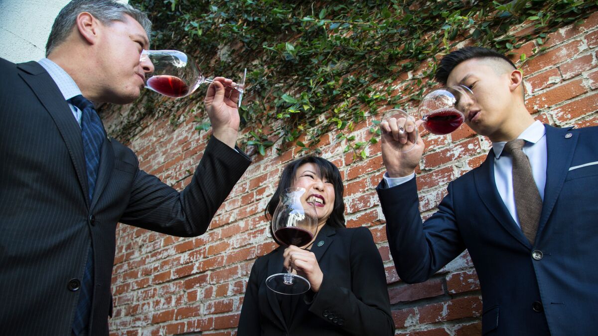 Spago wine director Phillip Dunn, left, assistant wine director Rina Bussell and cellarmaster Eric Denq taste a 2010 Gevrey-Chambertin French Burgundy.