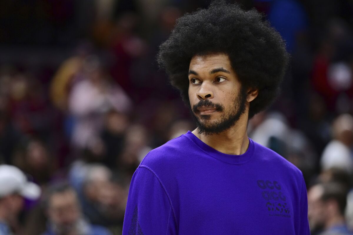 Cleveland Cavaliers center Jarrett Allen stands near the bench after the Cavaliers defeated the Milwaukee Bucks 133-115 in an NBA basketball game, Sunday, April 10, 2022, in Cleveland. (AP Photo/David Dermer)