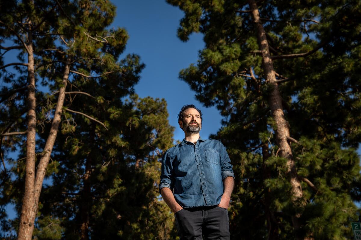 Author and playwright Dan O'Brien photographed against a backdrop of Canary Island pine trees in Santa Monica.