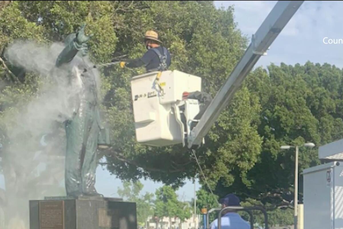 A statue of Martin Luther King Jr. is power washed after being vandalized.