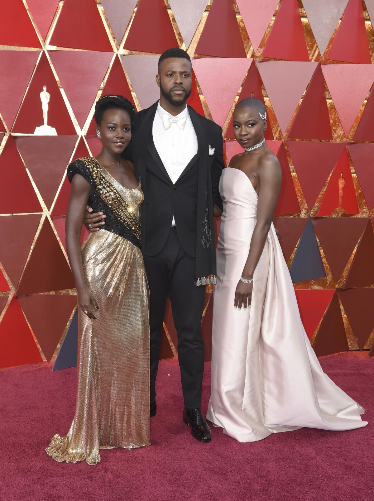 Lupita Nyong'o, left, Winston Duke, and Danai Gurira arrive at the Oscars.