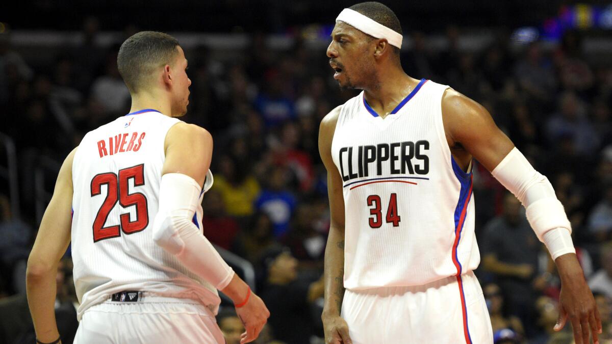 Clippers forward Paul Pierce (34) celebrates with guard Austin Rivers after making a three-pointer against the Trail Blazers in a preseason game Thursday night at Staples Center.