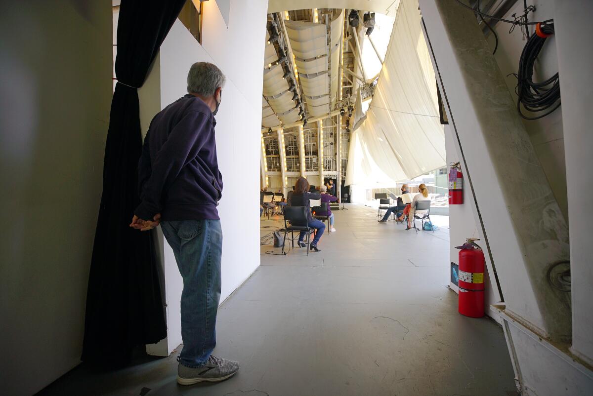 A master electrician studies the stage.