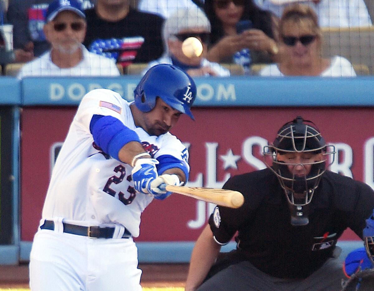 Dodgers first baseman Adrian Gonzalez hits a solo home run against Mets starter Matt Harvey on Saturday.