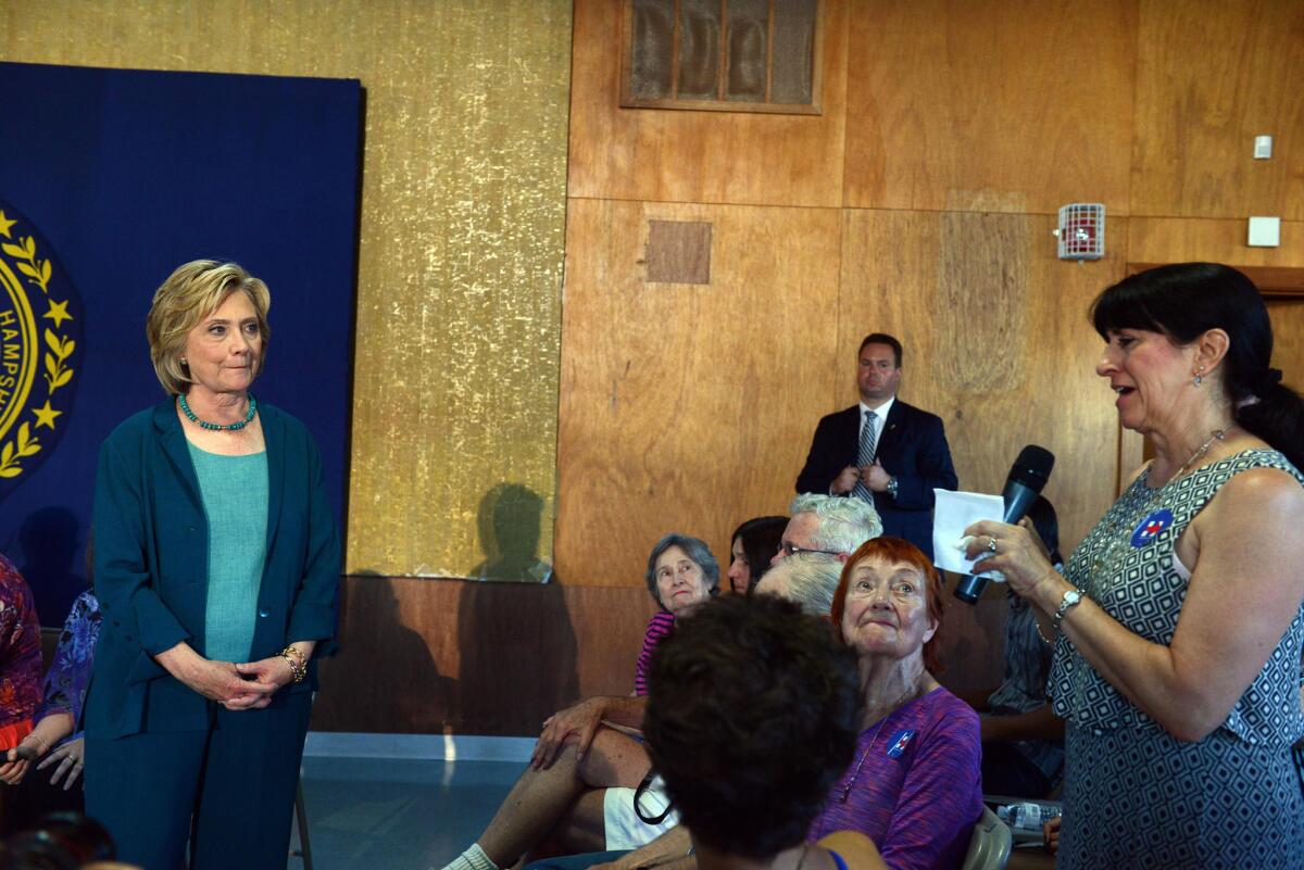 Democratic presidential candidate Hillary Clinton listens at a forum in Laconia, N.H., on Sept. 17 as Cindie Graham talks about losing a loved one to drugs.