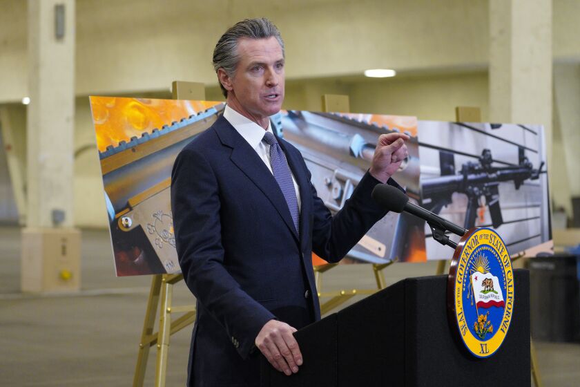 California Gov. Gavin Newsom along with several elected officials, met with the media at Del Mar Fairgrounds on Friday, Feb. 18, 2022, in Del Mar, Calif., where he backed state legislation that would allow for private citizens to enforce the state's ban on assault weapons. A new bill in California would allow private citizens go after gun makers in the same way Texas lets them target abortion providers, though gun advocates immediately promised a court challenge if it becomes law. (Nelvin C. Cepeda/The San Diego Union-Tribune via AP)
