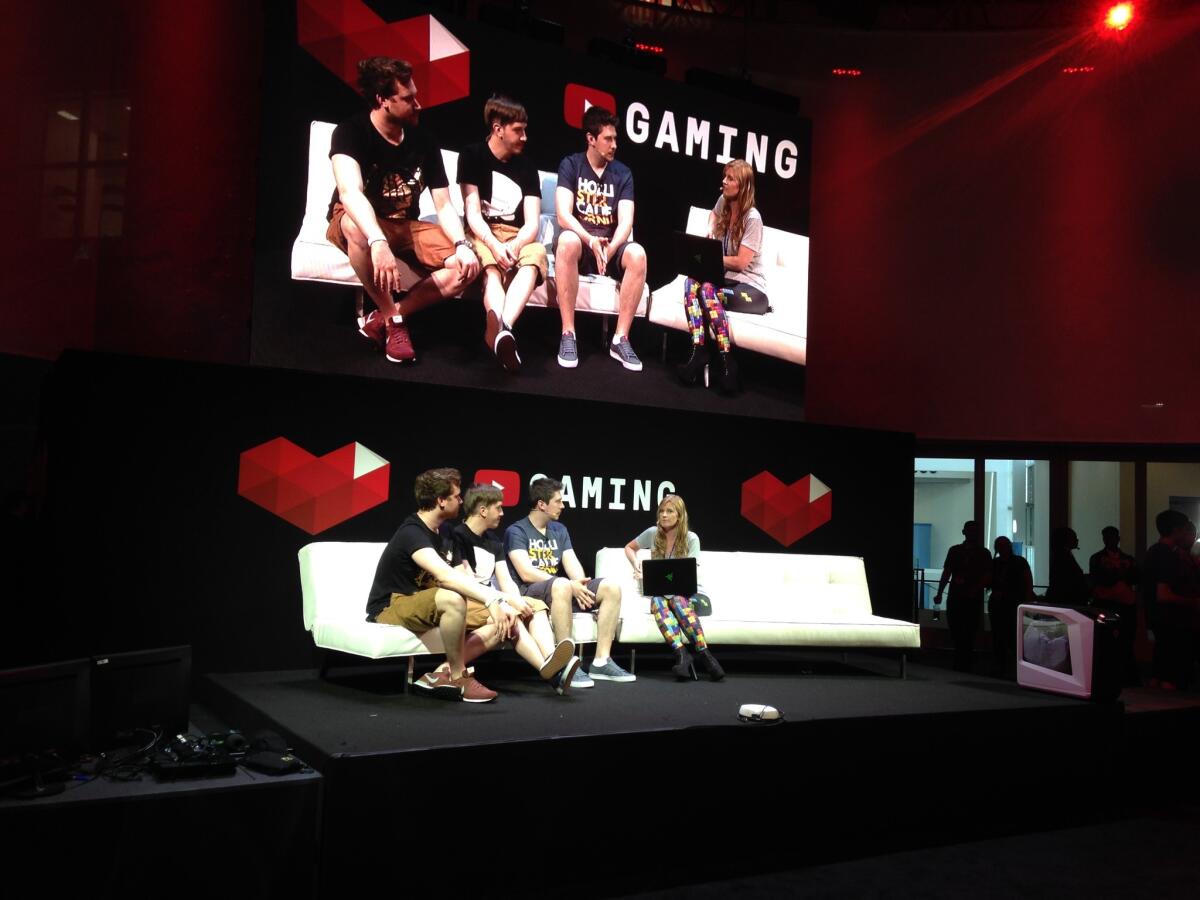 Video game developers discuss their work at the YouTube booth at the Electronic Entertainment Expo, promoting YouTube's new video game streaming site.