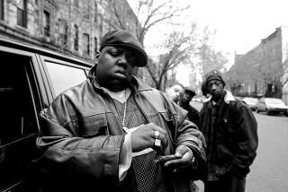 Notorious B.I.G., aka Biggie Smalls, aka Chris Wallace, rolls a cigar outside his mother's house in Brooklyn in 1995.