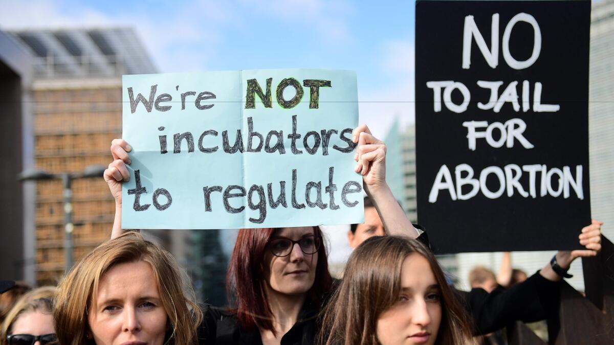 People protest against Poland's proposed near-total abortion ban in Brussels on Monday. (Emmanuel Dunland / AFP / Getty Images)