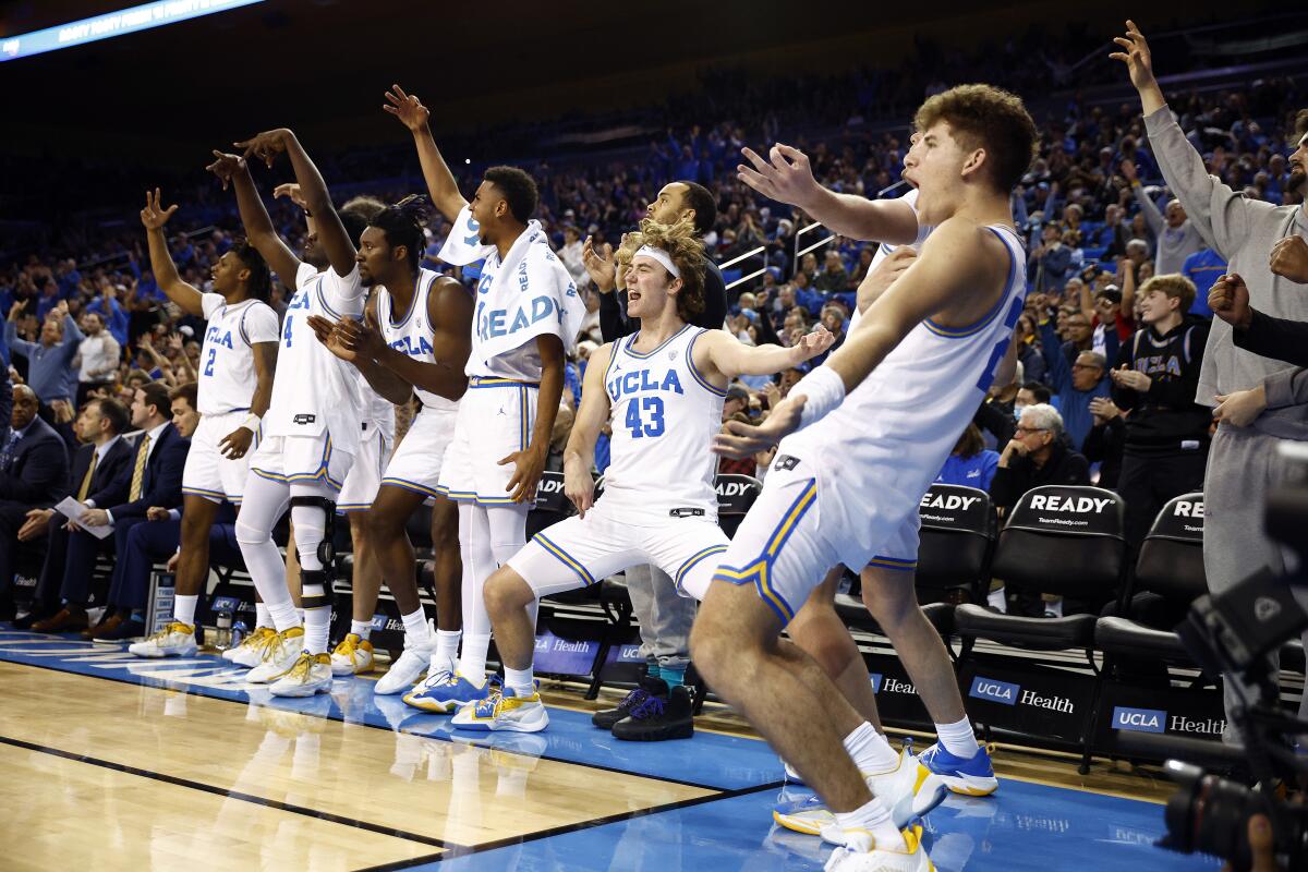Players on the UCLA bench are fired up during the second half against Colorado on Jan. 14, 2023, at Pauley Pavilion.