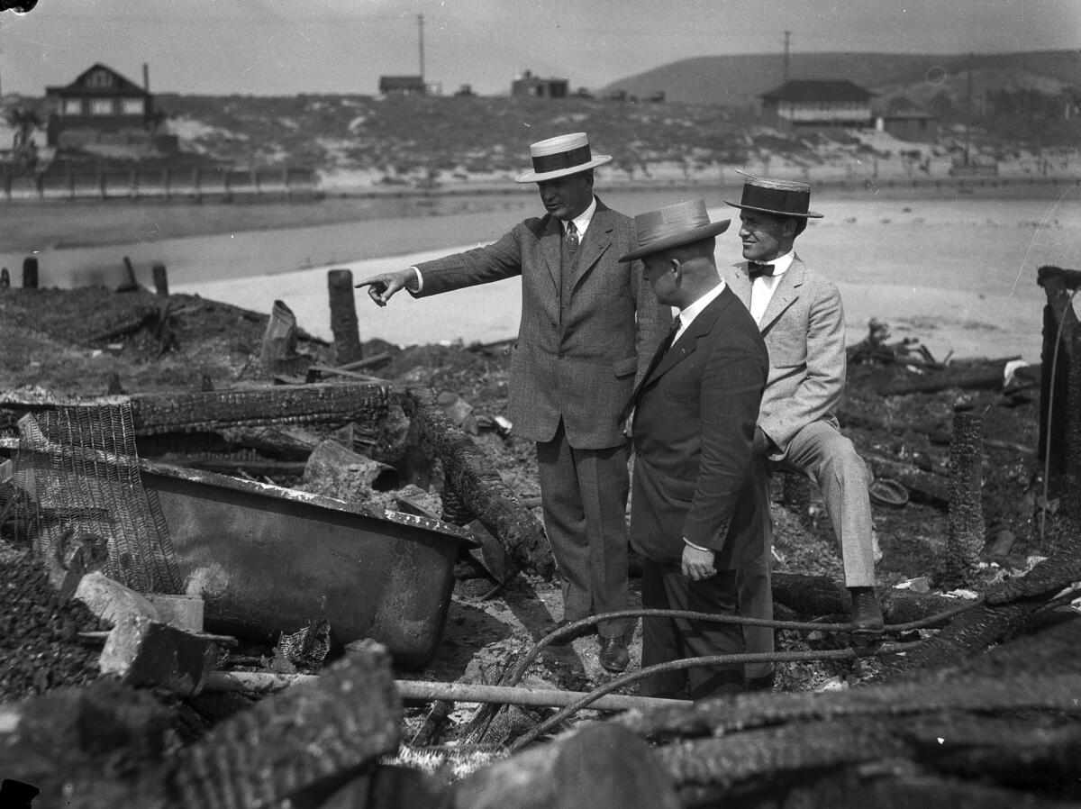 June 1924: Three men look over the charred remains of the Hope Development School in Playa del Rey.