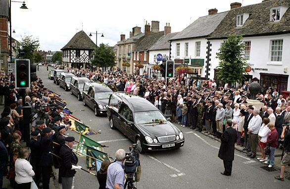 Hearses carrying the caskets of Lance Bombardier Matthew Hatton, 23, Rifleman Daniel Wild, 19, and Capt. Mark Hale, 42, pass mourners lining the main street of Wootton Bassett, England.