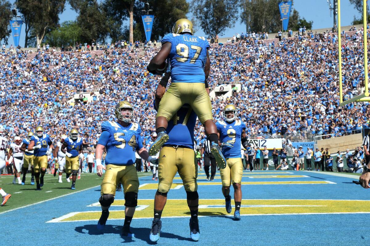 UCLA defensive lineman Eddie Vanderdoes collapsed to the ground after lifting fellow defensive lineman Kenny Clark in the air when Clark caught a three-yard touchdown pass.