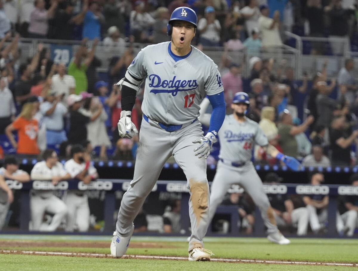 Dodgers' Shohei Ohtani reacts with his mouth wide open while running the bases after hitting his 50th home run of the year