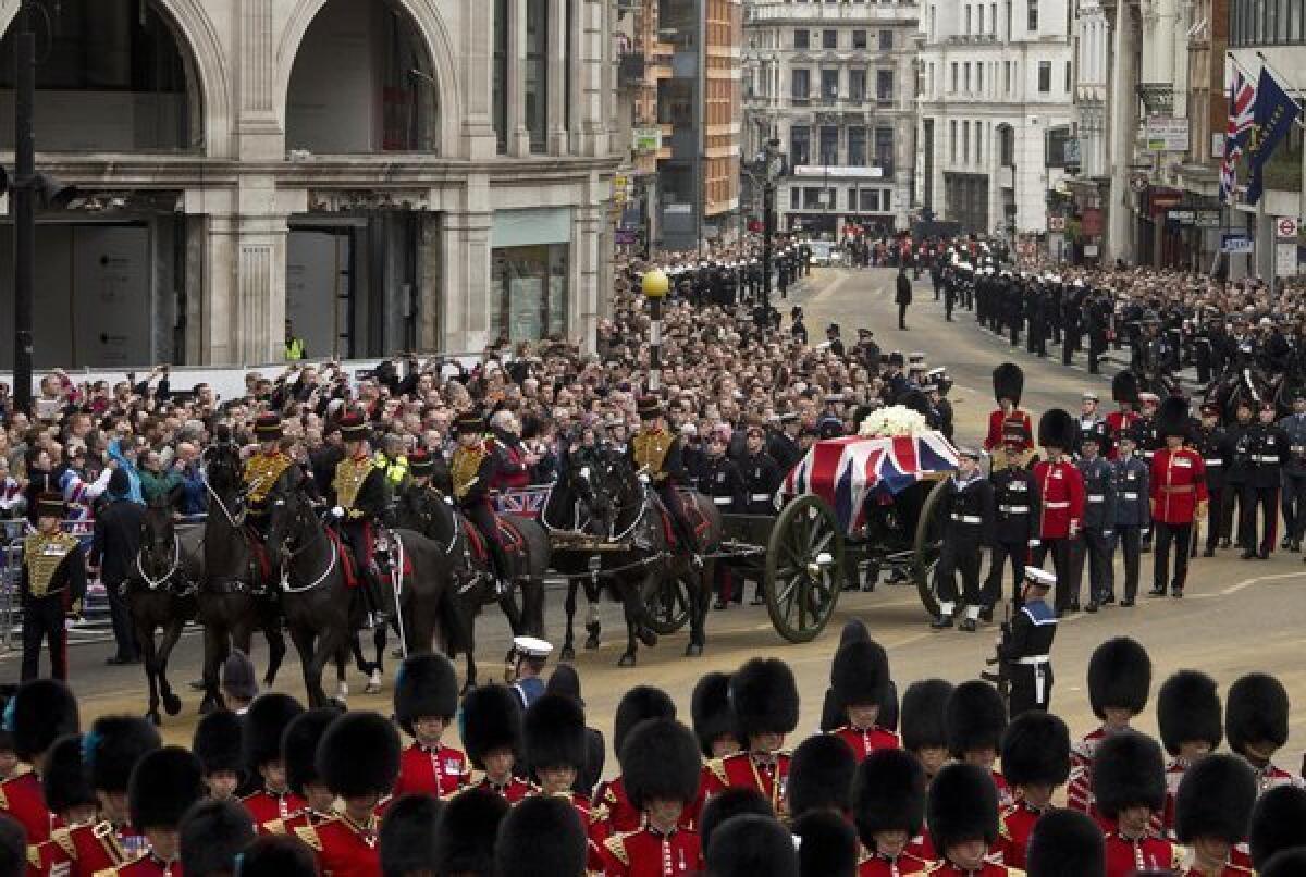 Crowds line the streets as the coffin of former British Prime Minister Margaret Thatcher is carried through central London on Wednesday.