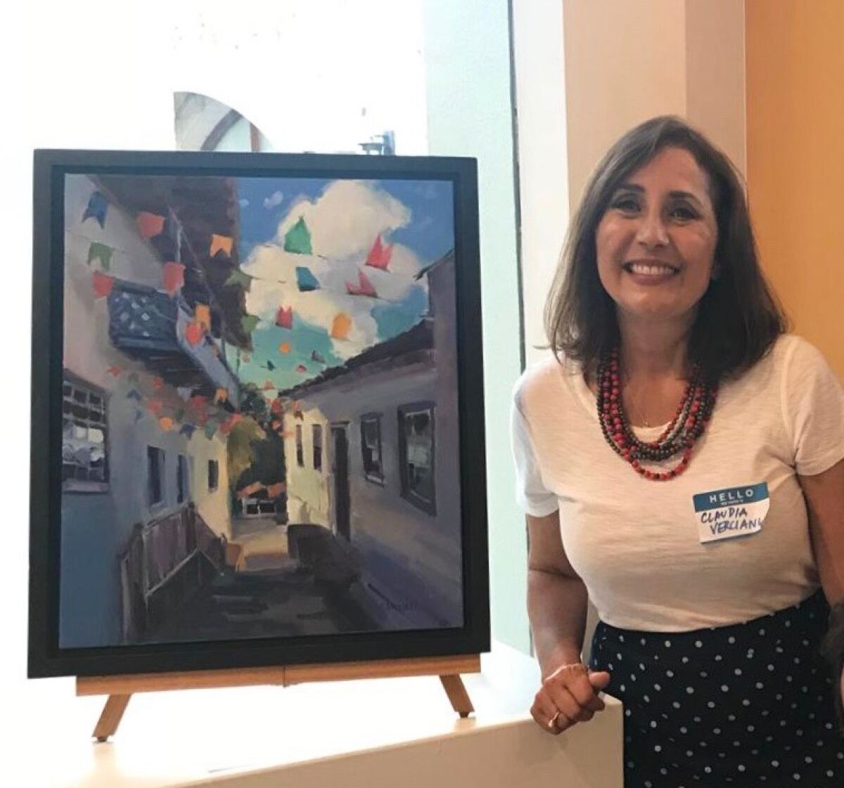 Artist Claudia Verciani with one of her pieces of artwork.