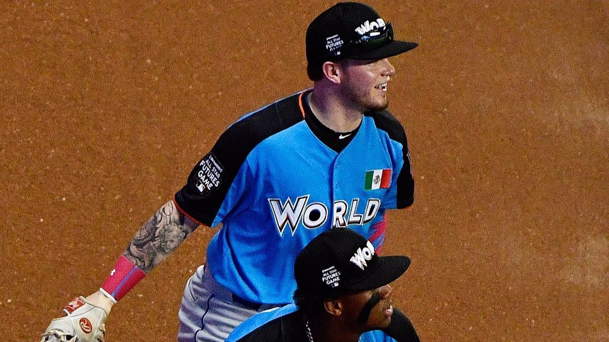 Dodgers prospect Alex Verdugo fields a ball over World Team teammate Ronald Acuna during the All-Star Futures Game at Marlins Park on Sunday in Miami.