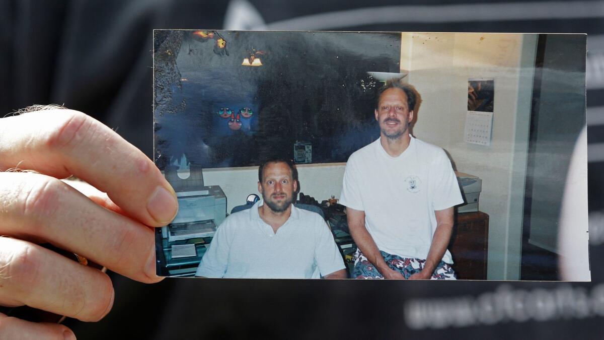 Eric Paddock in October 2017 holds a photo of himself, at left, and his brother, Las Vegas gunman Stephen Paddock.
