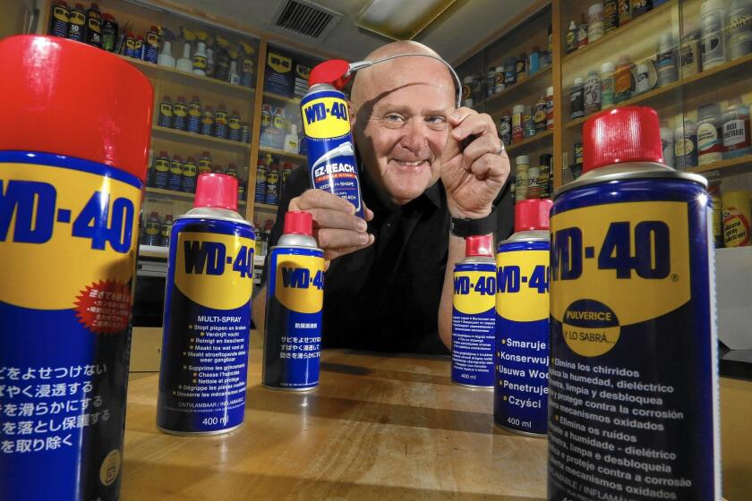 Garry Ridge, chief executive of WD-40, amid aerosol cans of his product at the company's San Diego headquarters.