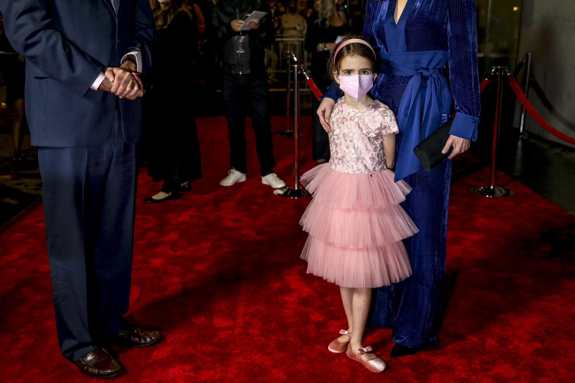 June Spencer, 6, daughter of cinematographer Alice Brooks, right, stands on the red carpet.