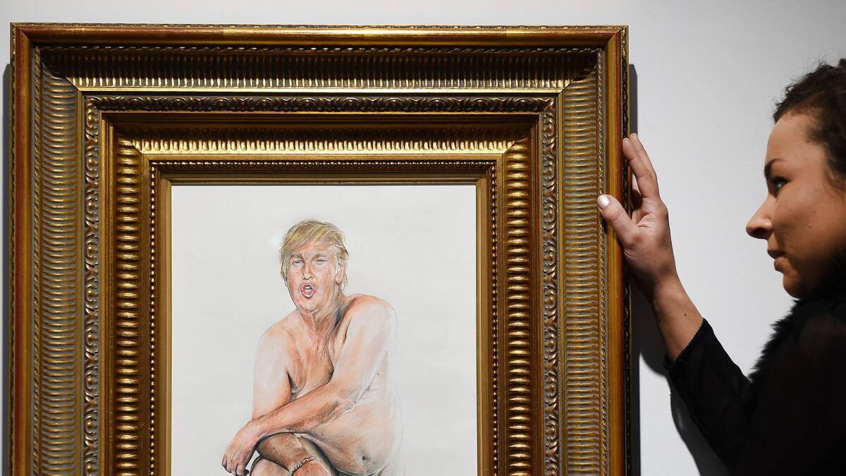 A woman adjusts "Make America Great Again," a painting by L.A. artist Illma Gore at London's Maddox Gallery.