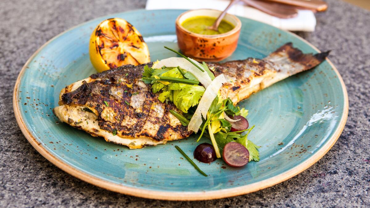 Whole grilled branzino, a type of sea bass, is among the fresh offerings on the menu at Herringbone, a fish restaurant at Aria. (Hakkasan Group)