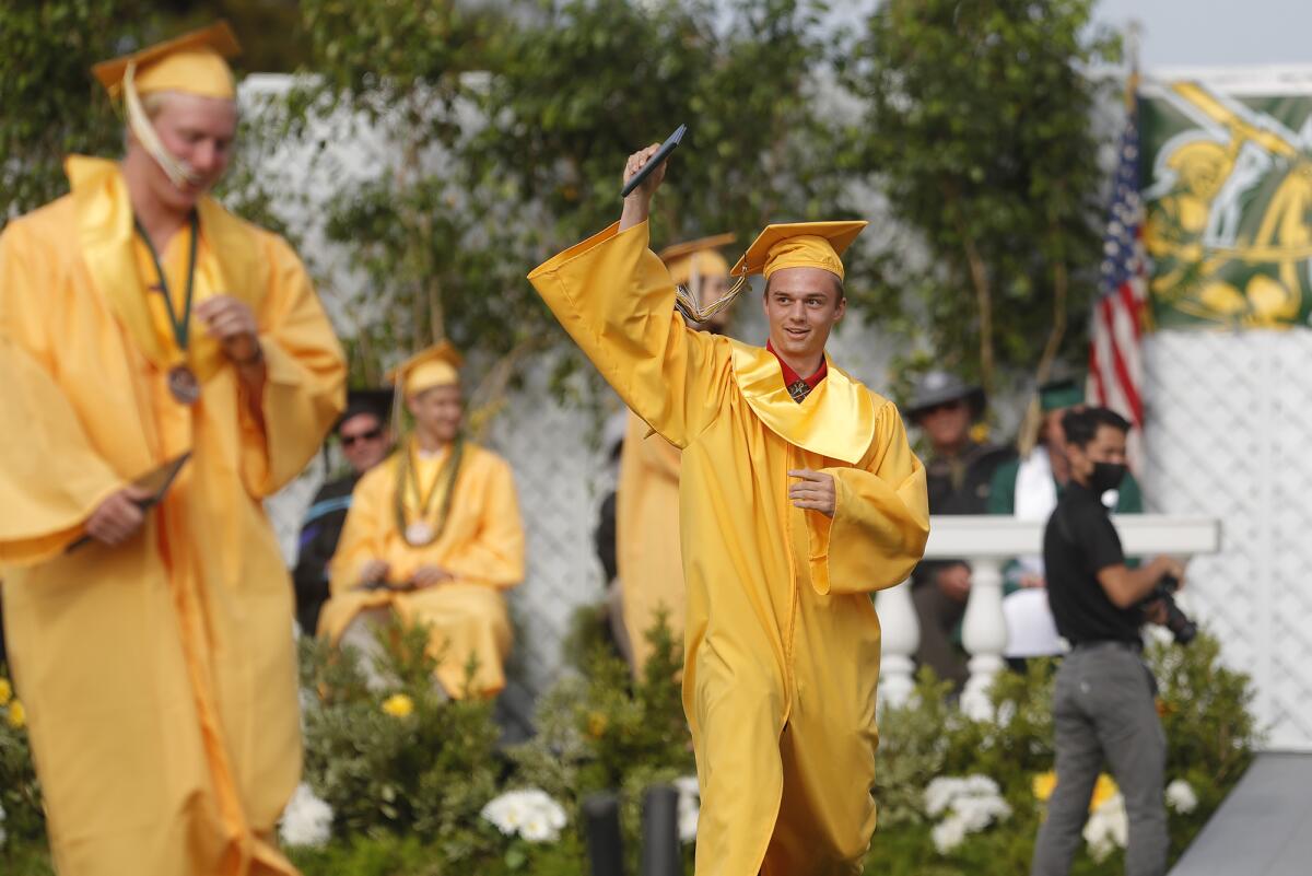 A happy graduate dances off the stage after receiving his diploma at Edison High.