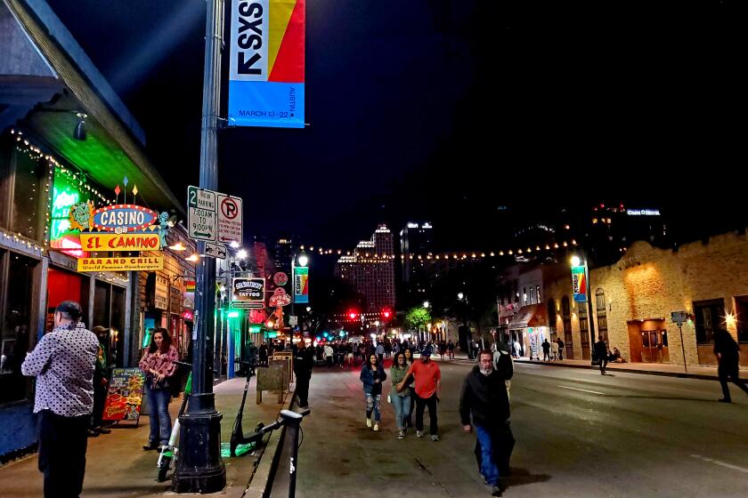 AUSTIN, TX. - MAR. 6, 2020 - Even after Austin's mayor effectively canceled the South by Southwest festival, people still flocked to downtown Sixth Street Friday night, Mar. 6, 2020. (Molly Hennessy-Fiske / Los Angeles Times)